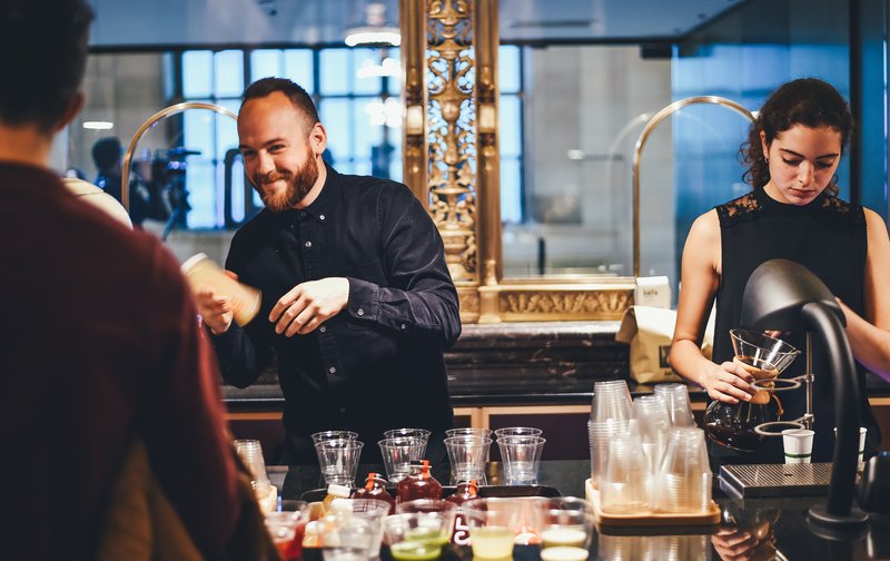 Happy Bartender at Work behind the Bar